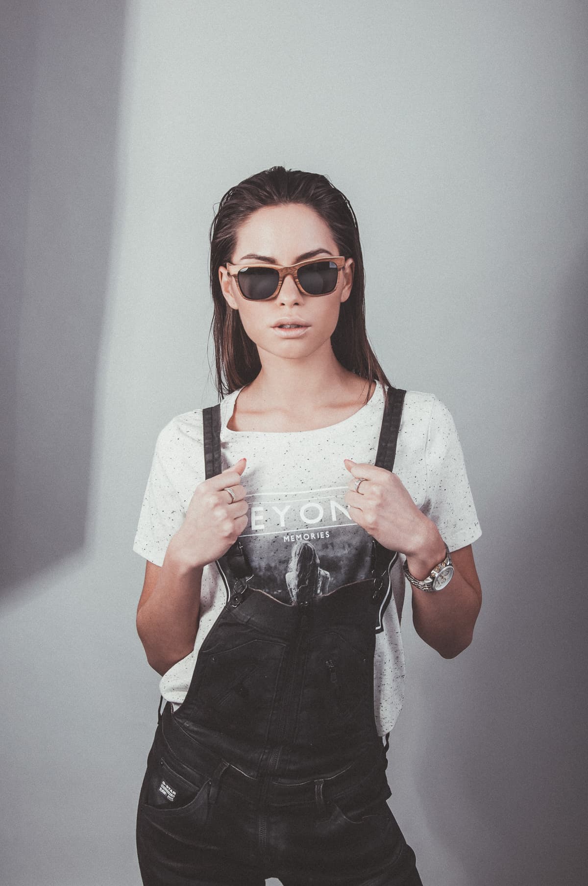 A woman wearing wooden Pray sunglasses, studio portrait from the See Through Nature campaign